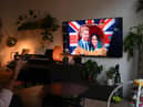 A woman watches an episode of the newly released Netflix docuseries "Harry and Meghan" about Britain's Prince Harry, Duke of Sussex, and Britain's Meghan, Duchess of Sussex, in London. Picture: Daniel Leal/AFP via Getty Images