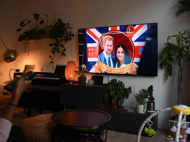 A woman watches an episode of the newly released Netflix docuseries "Harry and Meghan" about Britain's Prince Harry, Duke of Sussex, and Britain's Meghan, Duchess of Sussex, in London. Picture: Daniel Leal/AFP via Getty Images