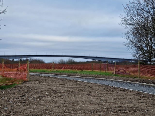 Works are steadily progressing on the new Derry bridge, which is due to be completed by Spring this year. The riverside path connecting the Bay Road Nature Reserve to the new bridge has kerbs and gravel laid and lampposts almost fully installed. The base for the bridge to sit on the Bay Road side seems to be fully complete with concrete being pored on the other side's base.