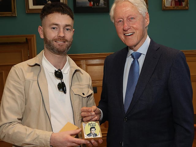 Bill Clinton receives a memento of his latest trip to Derry.