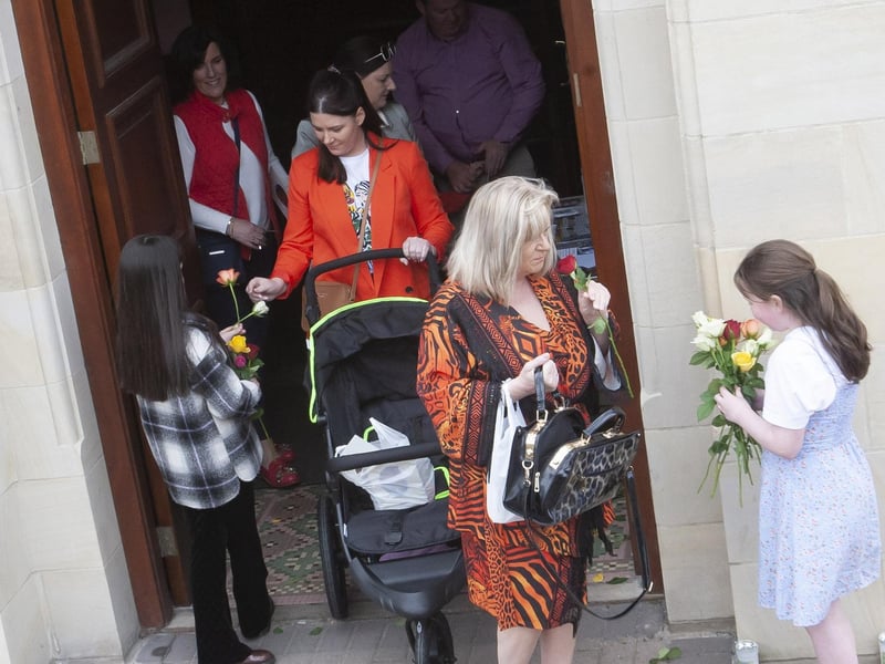 Children handing out flowers at the end of Sunday’s Sister Clare Crockett Retreat in the Long Tower Church.