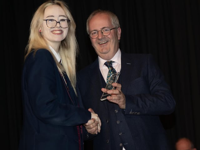 Emily Boyle receiving curriculum prizes for Business Communication Studies, French and Performance Arts from Mr. John Harkin, Principal, Oakgrove Integrated College.