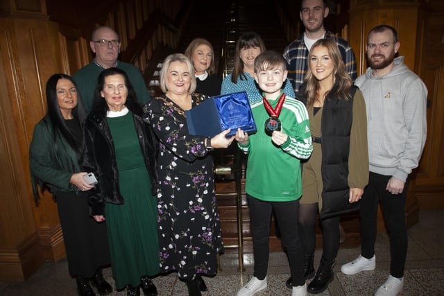 The Mayor of Derry City and Strabane District Council, Sandra Duffy making a special presentation to Strabane teenager Lucas O’Connell to mark his recent victory in the WUKF 12 Years Individual Boys Komite European Championship at a reception in his honour at the Guildhall on Tuesday evening last. Included are Lucas’ parents, grandparents, relatives and coaches.