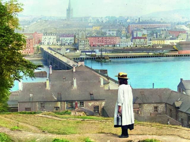 A young girl looks towards St Columb’s, a Church of Ireland cathedral built in Derry City after the reformation. It was the first non-Roman Catholic cathedral to be built in Western Europe. The old walled city lies on the west bank of the River Foyle, which is spanned here by Carlisle Bridge, which was replaced in the 1930s by Craigavon Bridge. Derry was one of the main emigration ports from Ulster to the USA in the nineteenth century. 
Photographer: Underwood & Underwood; Source: Library of Congress. Old Ireland In Colour 3 by John Breslin and Sarah Anne Buckley is published by Merrion Press