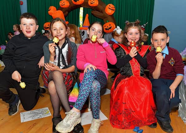 Pupils from St Eithne's Primary School enjoy a toffee apple at the Halloween picnic held on Wednesday afternoon last.  Photo: George Sweeney.  DER2243GS  048