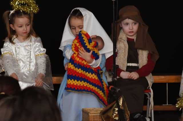 Mary cuddles the Baby Jesus during the Nursery Nativity Scene at Steelstown Primary School last week.