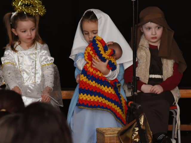 Mary cuddles the Baby Jesus during the Nursery Nativity Scene at Steelstown Primary School last week.