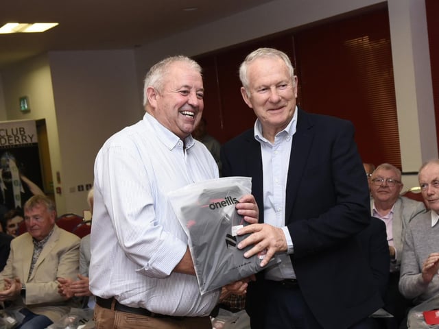 Derry Co. Chairman John Keenan makes a presentation to Ballerin's Malchy McAfee at the 1975 / 76 Ulster SFC Winners reunion in Owenbeg on Friday.