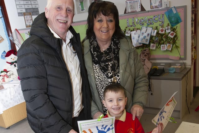Nursery pupil Cahir shows his grandparents some of his artwork during Wednesday’s event at Steelstown PS.