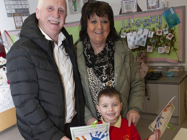 Nursery pupil Cahir shows his grandparents some of his artwork during Wednesday’s event at Steelstown PS.
