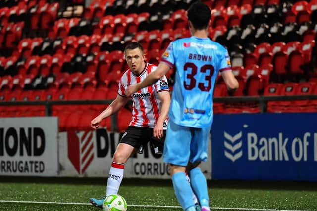 Institute’s Dean Brown tracks Shane Ferguson of Derry City. Photograph: George Sweeney