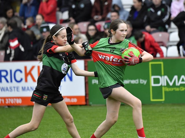 Young footballers from Doire Trasna and Slaughtmanus Under 12 teams play at half-time at the Derry Junior Football Championship Final held in Celtic Park on Sunday afternoon. Photo: George Sweeney