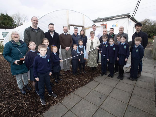 BIG GARDEN LAUNCH AT HOLLYBUSH PS. . . . .Pupils from Hollybush PS cutting the ribbon to officially open their new polytunnel and launch their new food growing garden project supported by Natural World Products (NWP).  Included in photo are Colum Eastwood Foyle MP, Mark Durkan MLA, Colm Warren NWP, Feargal Friel, Acting Principal, Cahir O'Connor, Vice Principal, Gareth Lamrock, ECO Schools Education Officer, Allan Bogle Acorn Farm, Sharon McMaster Community Outreach Manager and Horticulturist for NWP, Patricia McCormick, After-School Garden Club Facilitator, Andy McDermott, school caretaker and board of governors representatives Paul Kirby and Angela Dobbins. (Photos: Jim McCafferty Photography)