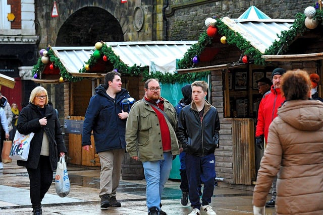 People visiting the Christmas Market in Guildhall Square on Friday afternoon. Photo: George Sweeney. DER2250GS – 65
