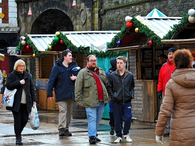 People visiting the Christmas Market in Guildhall Square on Friday afternoon. Photo: George Sweeney. DER2250GS – 65