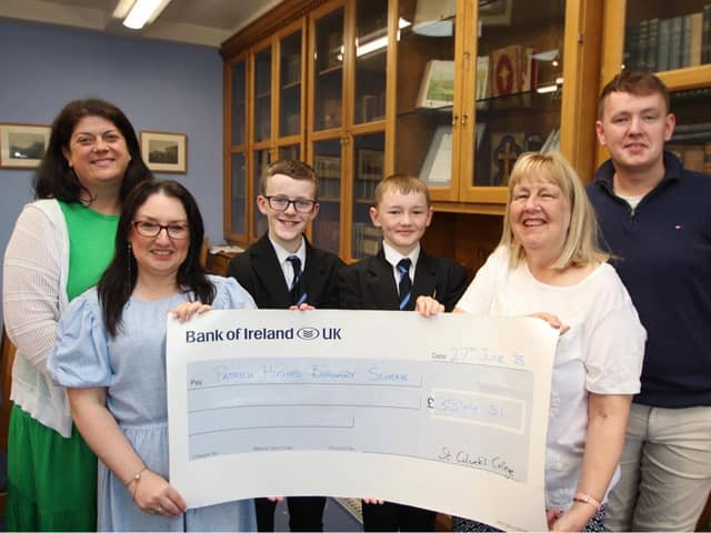 St. Columb’s College students and staff present a cheque for £3455.51 to the Patricia Hughes Bursary Scheme