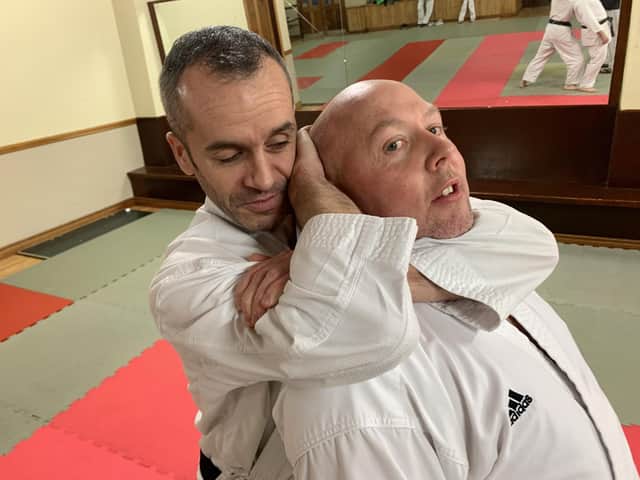 Aileach Karate Club instructor, Seamus Gillespie, performs a self defence demonstration with the help of clubmate Gareth Walker.