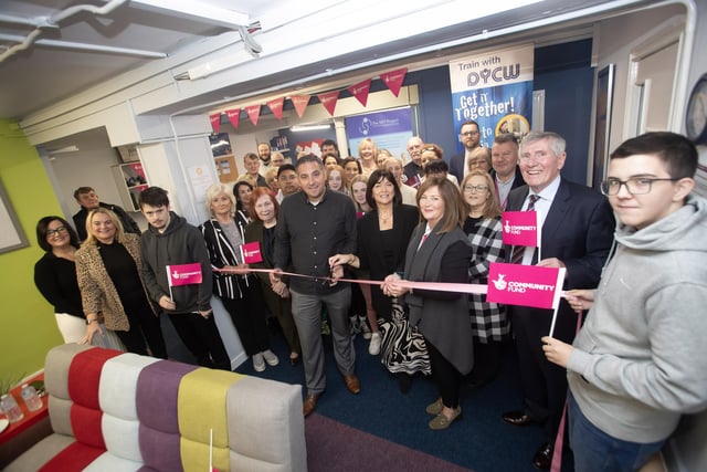 SKY PROJECT LAUNCH. . . .Councillor Christopher Jackson (representing the Mayor, Lillian Seenoi-Barr) officially cuts the ribbon to launch the SKY Project at the Derry Youth and Community Workshop on Friday last at their Society Street premises. Included are DYCW board members, staff and service users, National Lottery representatives, local councillors and MLAs and community groups representatives. (Photos: Jim McCafferty Photography)