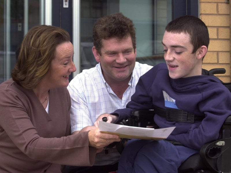 A delighted Donovan McKeever pictured with his parents, Teresa and Brendan, after receiving his GCSE results yesterday at St Joseph's Boys School.