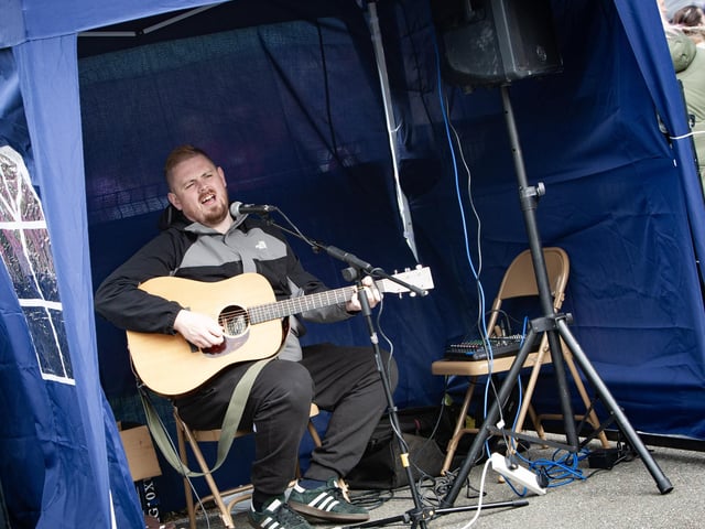 Musician Justin Morrow entertains the crowd at the Summer Fair on Friday night.