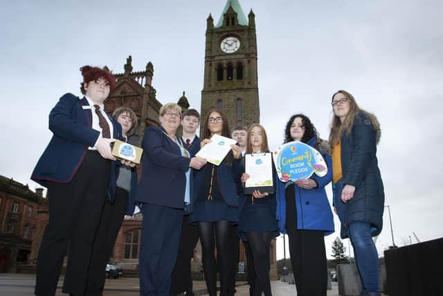 The Deputy Mayor of Derry City and Strabane District Council, Angela Dobbins endorsing the Oakgrove Integrated College Community Book Pledge when she met some of the students and teaching staff at Guildhall Square on Friday morning last. The students then called to local businesses in the city for sponsorship with the aim to collect £1,000 for the school to go towards books for the library. This will be added to by Usborne with an additional £600 of free books for the school. (Photos: Jim McCafferty Photography)