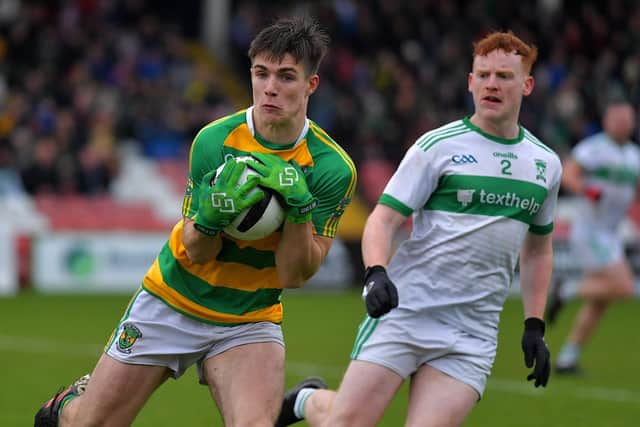Glenullin ‘s Ryan McNicholl captures the ball ahead of  Con Magees’ Charlie Henry. Photo: George Sweeney