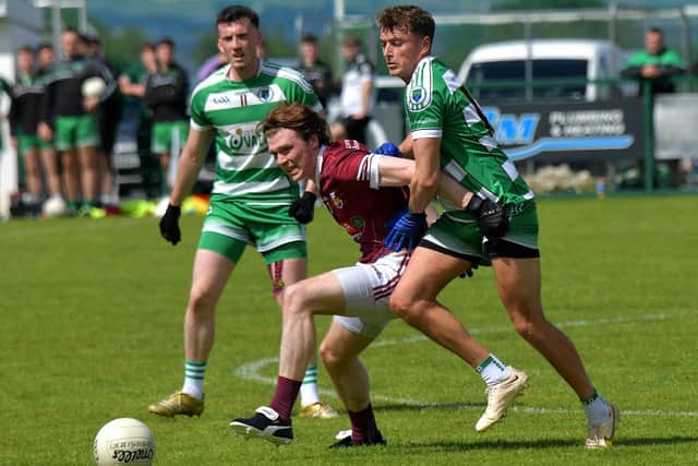 Faughanvale’s Kevin Martin tackles Cathair McGilligan of Banagher. Photo: George Sweeney. DER2331GS – 83
