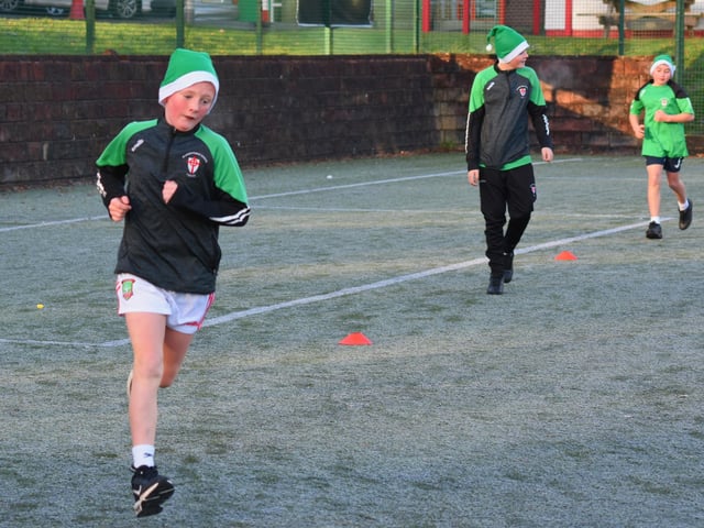 St. Joseph's Boys School students Jake, Patrick and John near completion of Tuesday's Santa's Run.