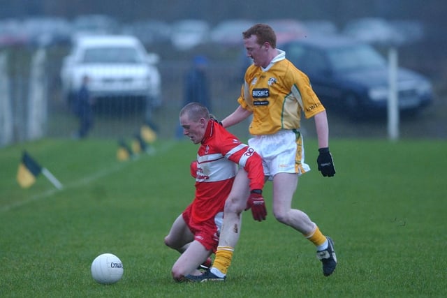 Derry's Patsy Bradley holds off an Antrim player at Glen in the 2004 Dr. McKenna Cup tie.