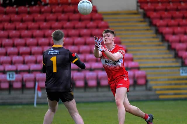 Antrim’s Eoghan O’Hare grapples with Derry’s Ryan McNicholl. Photo: George Sweeney