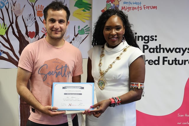 Amir Alshamiri with his certificate and gift. Amir has been an integral part of the North West Migrants Forum since arriving in Northern Ireland.