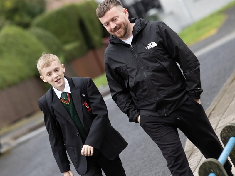 Father and son make their way through the gates of St. Joseph's Boys School on Friday morning.