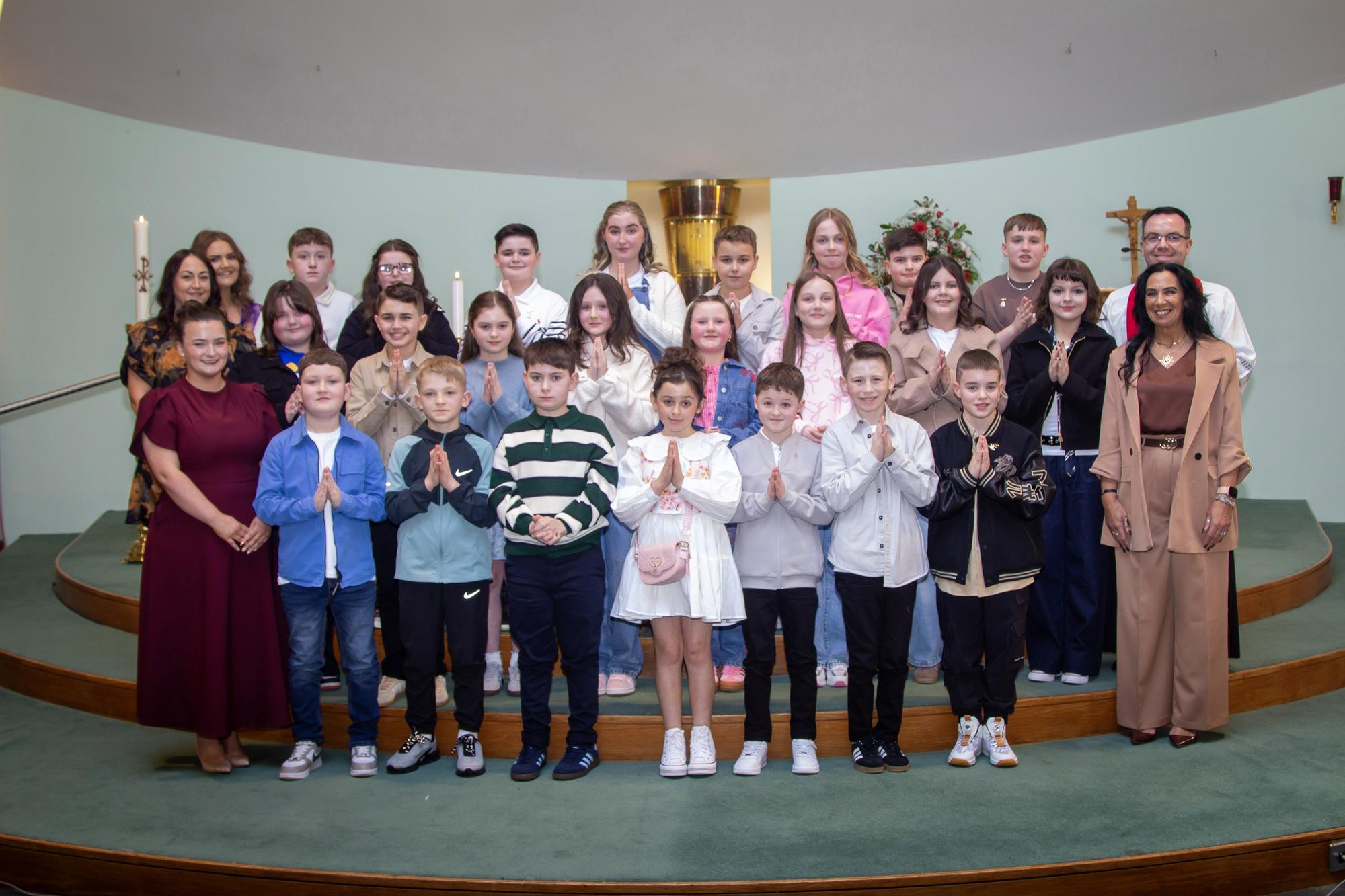 Mrs. McKane's Y7EK class from Sacred Heart PS, who received the Sacrament of Confirmation from Fr. Patrick Lagan at the Church of the Immaculate Conception, Trench Road, Waterside last Thursday.. Included in photo is Mrs. Elaine Sweeney, Miss Jessica Curley and Mrs. Seana Duddy, Classroom Assistants. (Photo: Jim McCafferty Photography)