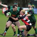 City of Derry’s Simon Logue keeps Aaron McMurray of Cooke at arm’s length. Photo: George Sweeney