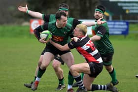 City of Derry’s Simon Logue keeps Aaron McMurray of Cooke at arm’s length. Photo: George Sweeney