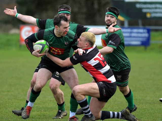 City of Derry’s Simon Logue keeps Aaron McMurray of Cooke at arm’s length. Photo: George Sweeney