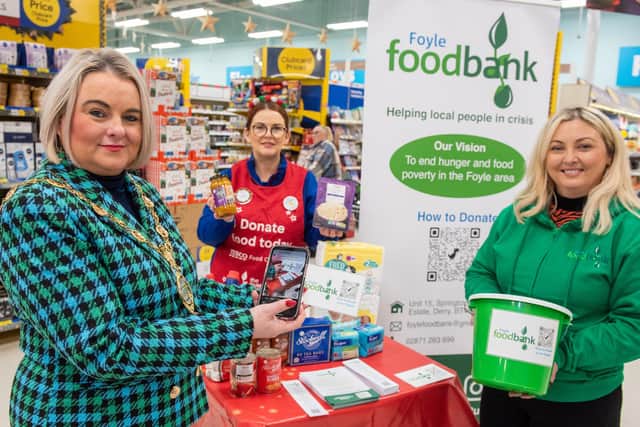 DECEMBER: Mayor Sandra Duffy at the launch of the Tesco Food Drive in Quayside with Karen Mullan, Foyle Foodbank and Fionnuala O’Reilly, Tesco Community Champion. Picture Martin McKeown. 01.12.22