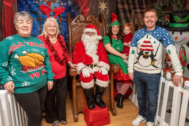 Getting festive in Caw…Welcoming Santa at the Caw/Nelson Drive Action Group’s Crescent Community & Cultural Centre is Andy Mullan, Housing Executive Good Relations Officer, with 3 year old Scarlett, her mum Rachel, her granny Joanna and Linda Watson BEM, centre co-ordinator. This special Santa’s Grotto experience was funded by a Housing Executive Community Cohesion grant which enabled local families to meet Santa, get professional Christmas photographs taken and also ensured that every child went home with a present to put under the tree.