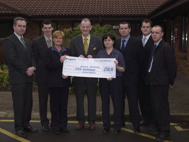 Dr Tom McGinley receiving a cheque for the Foyle Hospice from Musgrave representatives.