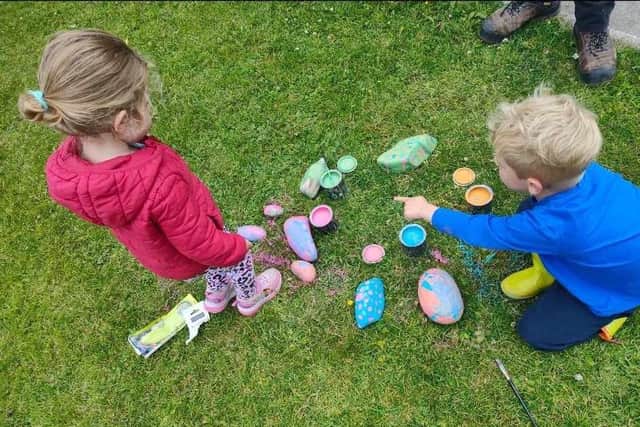 Tegan and Logan paint their rocks.