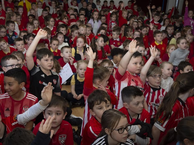 Young pupils at Steelstown Primary School during the visit of Patrick and Shane McEleney and Michael Duffy to the school on Tuesday. (Photo: Jim McCafferty)
