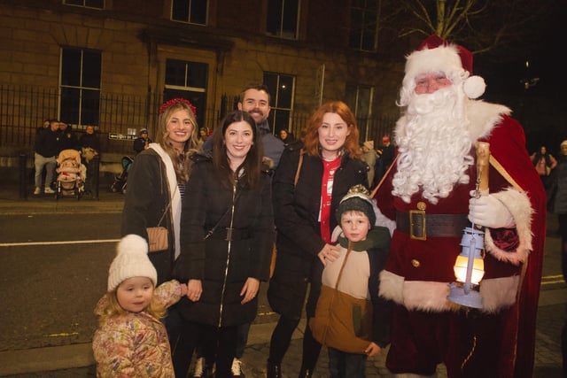 Local families with Santa during the procession.