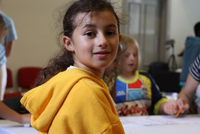 Ellie gives the camera a glance as she waits for the art class to begin.