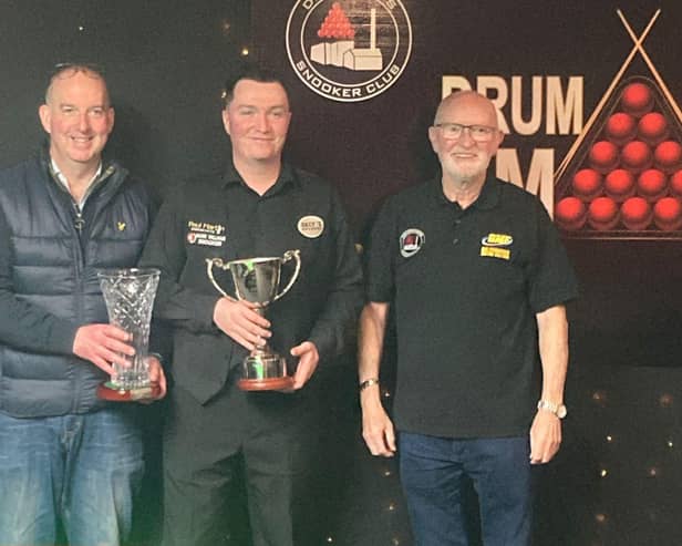 Shea Moore, winner of the 2025 Drumaness Masters, receives his trophy from tournament organisers on Wednesday night.