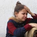 A Palestinian girl mourns a relative, killed in an Israeli strike on a school-turned-shelter, at the Al-Shifa hospital in Gaza City on April 23, 2025. Israel resumed its military campaign in Gaza on March 18, following the collapse of a two-month ceasefire that had largely halted the fighting in the besieged Palestinian territory. (Photo by Omar AL-QATTAA / AFP) (Photo by OMAR AL-QATTAA/AFP via Getty Images)