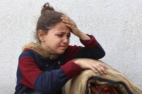 A Palestinian girl mourns a relative, killed in an Israeli strike on a school-turned-shelter, at the Al-Shifa hospital in Gaza City on April 23, 2025. Israel resumed its military campaign in Gaza on March 18, following the collapse of a two-month ceasefire that had largely halted the fighting in the besieged Palestinian territory. (Photo by Omar AL-QATTAA / AFP) (Photo by OMAR AL-QATTAA/AFP via Getty Images)