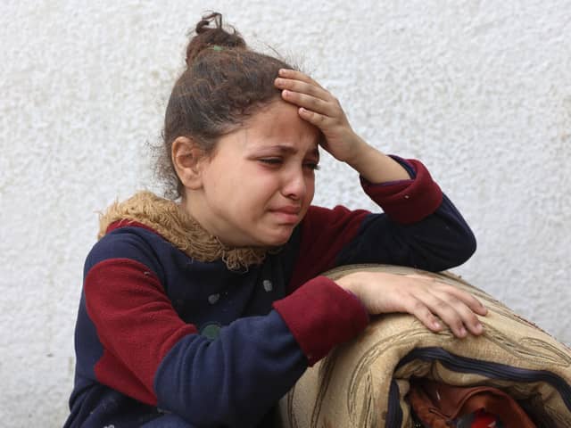 A Palestinian girl mourns a relative, killed in an Israeli strike on a school-turned-shelter, at the Al-Shifa hospital in Gaza City on April 23, 2025. Israel resumed its military campaign in Gaza on March 18, following the collapse of a two-month ceasefire that had largely halted the fighting in the besieged Palestinian territory. (Photo by Omar AL-QATTAA / AFP) (Photo by OMAR AL-QATTAA/AFP via Getty Images)