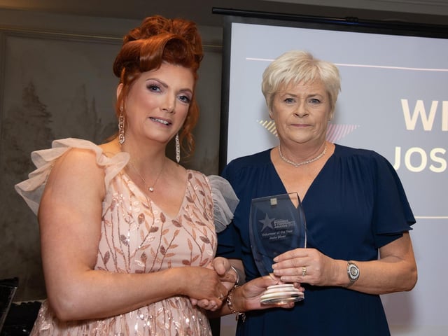Tina O'Donnell presents the Volunteer of the Yeard Award sposnored by Lansdown Hotel to Anne Diver collecting for the the late Josie Diver at the Carndonagh Traders Business and Community Awards in the Ballyliffin Lodge Hotel on Saturday night last. Photo Clive Wasson.
