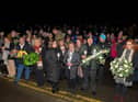 Local people, friends and relatives gather at Strabane Old Road on Tuesday evening for a wreath laying event marking the 50th Anniversary of the Annie’s Bar massacre. Photo: George Sweeney. DER2251GS – 13