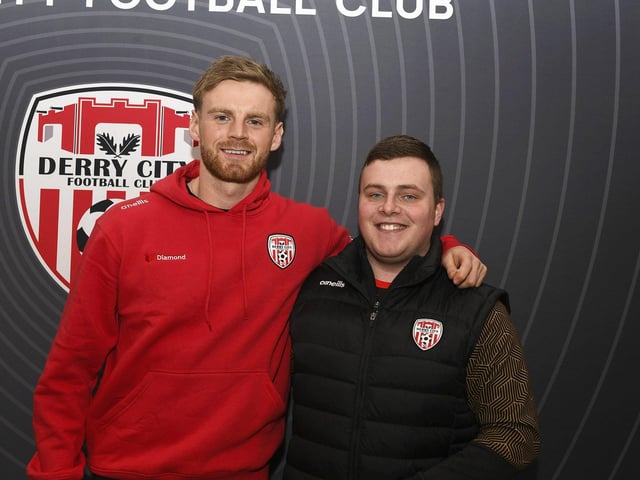 Candystripe fan Ciaran Divin pictured with Derry City's Rob Slevin at the club's merchandise outlet in Foyleside Shopping Centre. Photo: George Sweeney